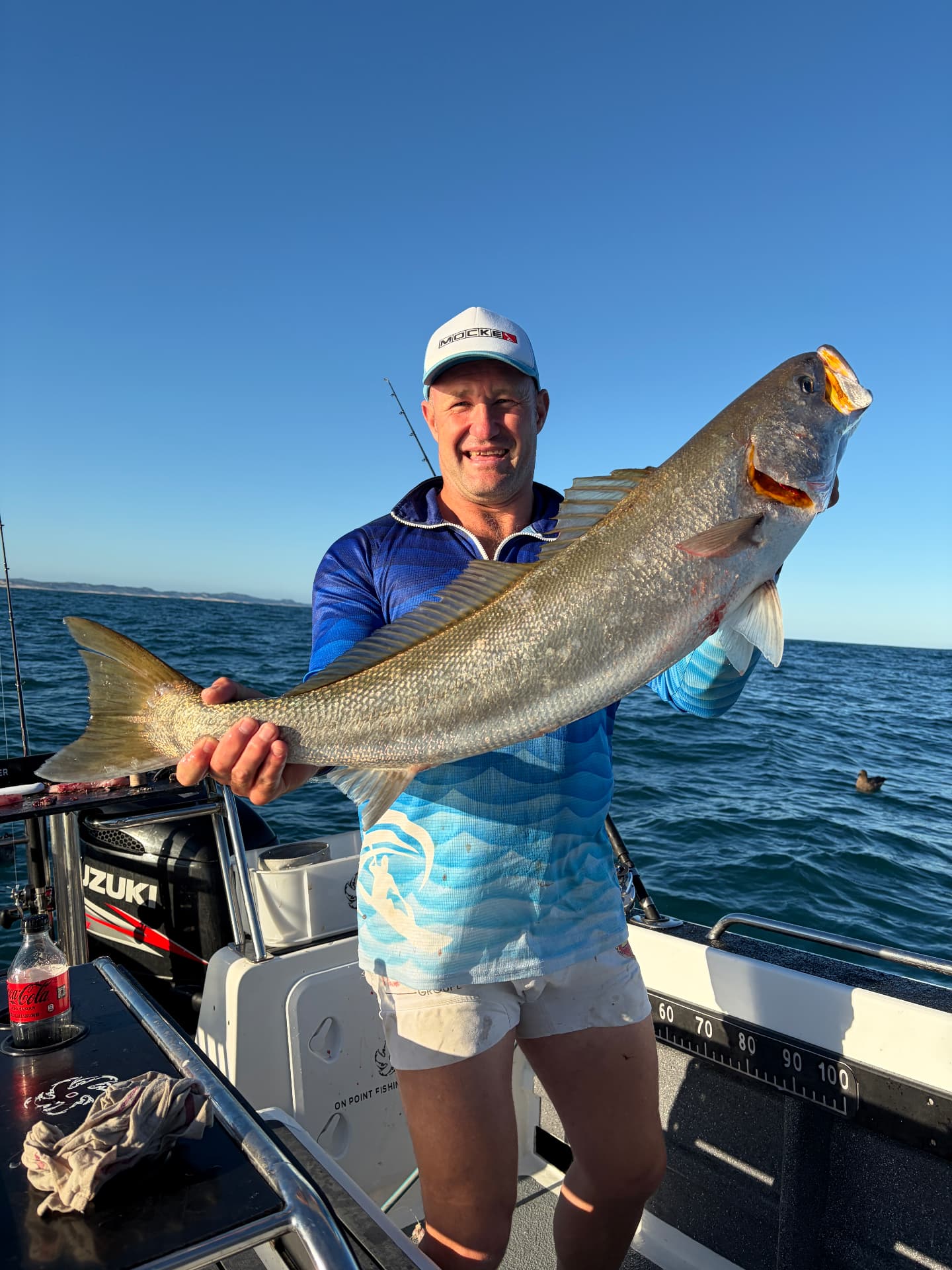 Angler holding a fish on deck off Port Alfred